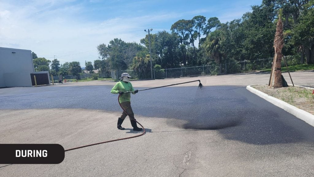 G-FORCE® employee applying new asphalt to parking lot for O'Reilly's Auto Parts and shopping center