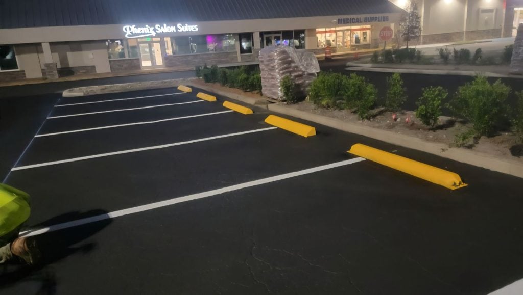 close-up of freshly painted parking spots for O'Reilly's Auto Parts and shopping center