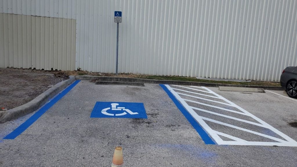 front view of ada compliance parking spot freshly painted for private business