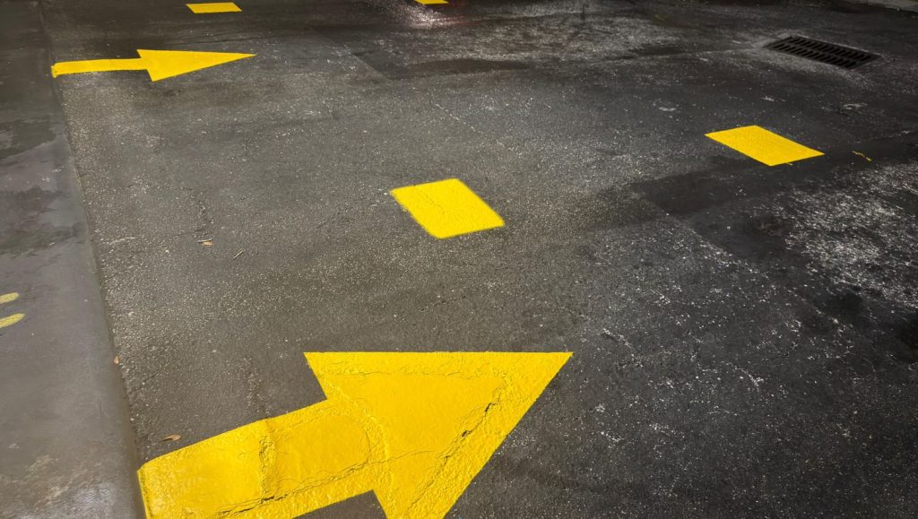 close-up of yellow arrows freshly painted for Jiffy Lube