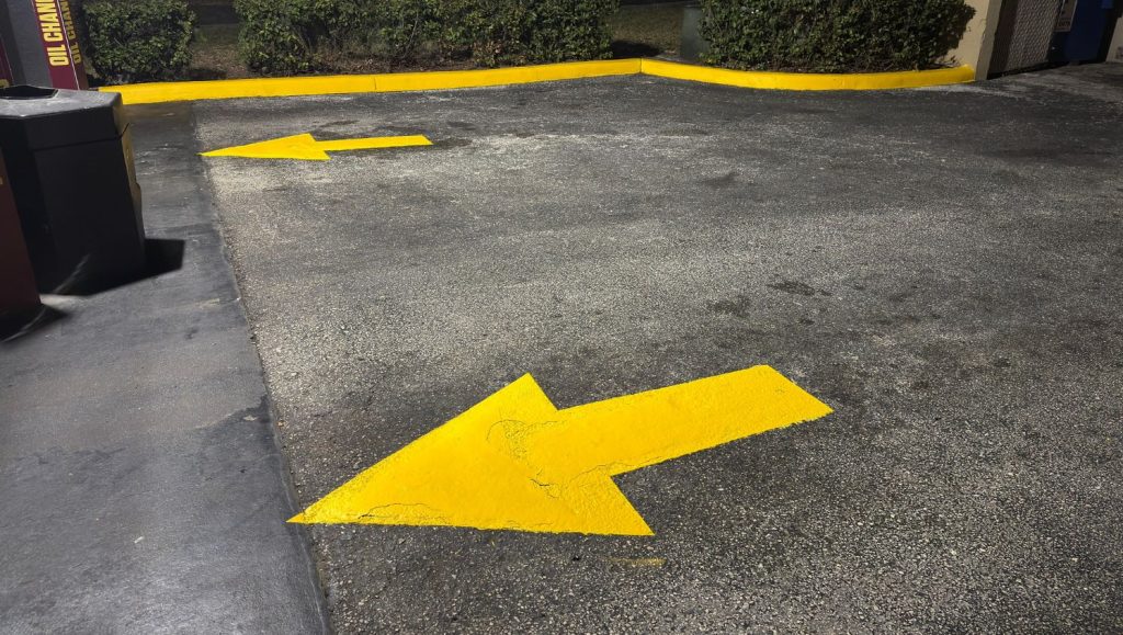 Jiffy Lube parking lot with freshly painted yellow arrows.