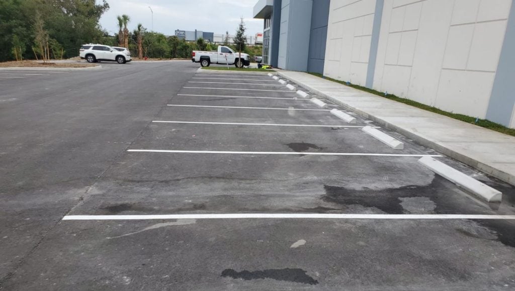 parking spots freshly painted for business parking lot with stops