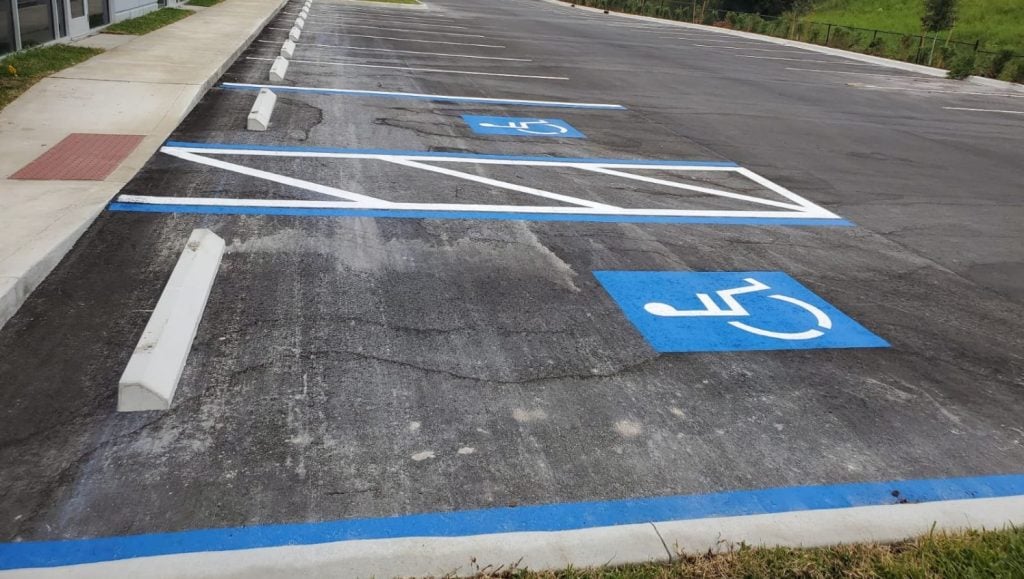 ada compliance parking spot freshly painted for business parking lot close-up