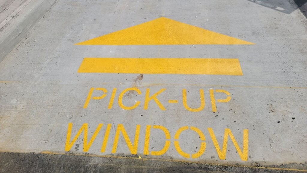 yellow line markings freshly painted for Wendy's parking lot