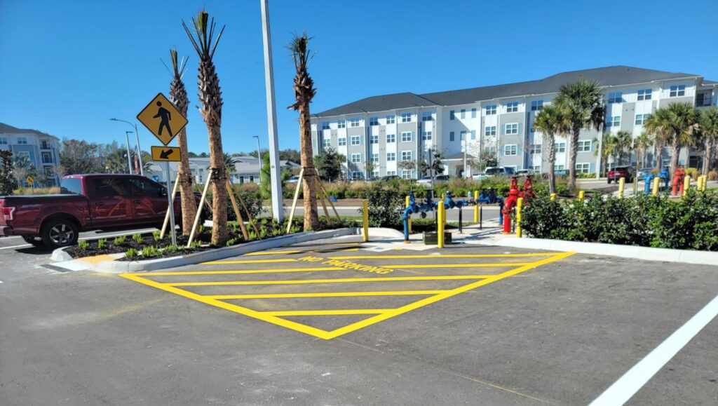 yellow crosswalk freshly painted for The Hub parking lot