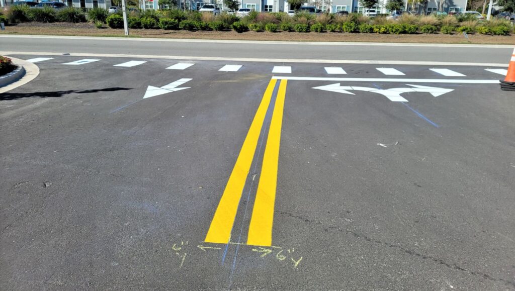 yellow line markings freshly painted for The Hub parking lot