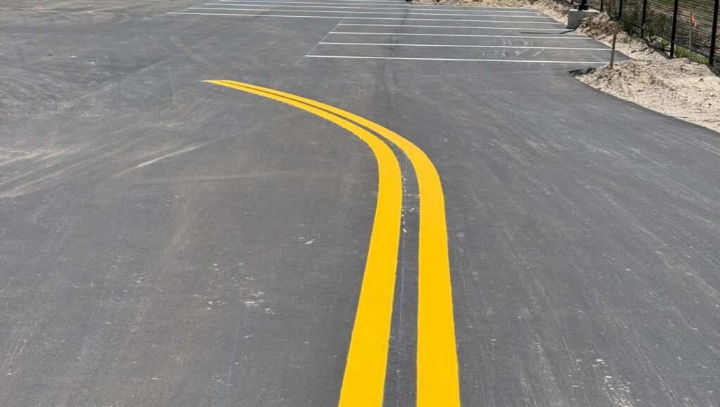 close-up of yellow line striping freshly painted for new business parking lot