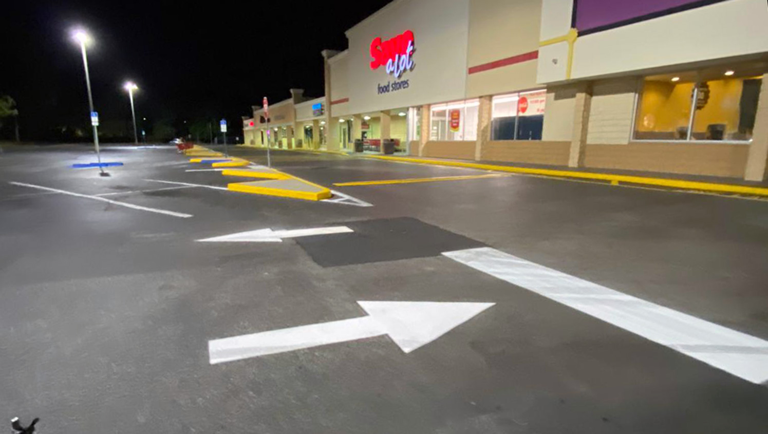 freshly striped parking lot arrows at a Tampa, FL shopping plaza