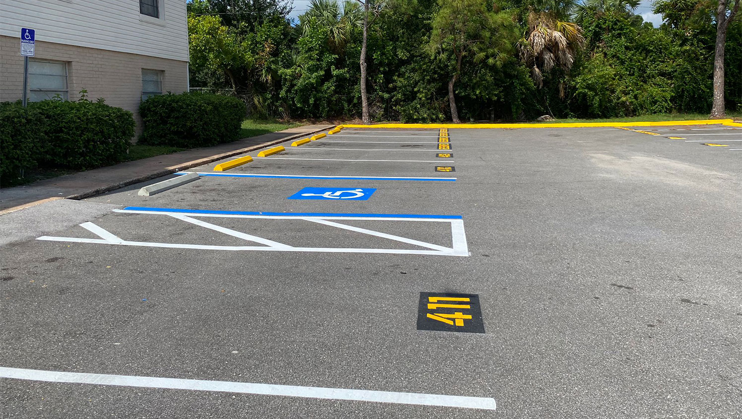 ada stall painted on asphalt with apartment number markings