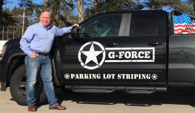 jack child in front of gforce pickup truck