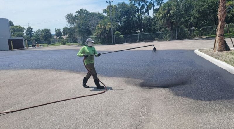 G-FORCE worker sealcoating a parking lot